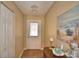 Inviting entryway with wood-look floors, closet, and decorative painting with a coastal theme at 492 Sweetwater Way, Haines City, FL 33844