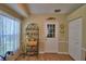 Bright kitchen nook with wood floors, shelving, and a door to the outside at 492 Sweetwater Way, Haines City, FL 33844