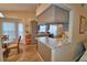 Charming kitchen with grey cabinetry, tile backsplash, eat-in nook, and breakfast bar at 492 Sweetwater Way, Haines City, FL 33844