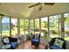 This spacious lanai includes tile flooring, ceiling fan, and wicker furniture for comfortable outdoor seating at 492 Sweetwater Way, Haines City, FL 33844