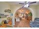 Bright living room with open archway, hardwood floors, and convenient access to the rest of the house at 492 Sweetwater Way, Haines City, FL 33844