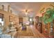 Spacious living room with high ceilings, ceiling fan, hardwood floors, and a comfortable seating area at 492 Sweetwater Way, Haines City, FL 33844