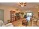 Cozy living room with vaulted ceilings, ceiling fan, and a seamless flow to the outdoor living area at 492 Sweetwater Way, Haines City, FL 33844