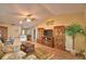 Comfortable living room featuring vaulted ceilings, a ceiling fan, and warm, neutral decor at 492 Sweetwater Way, Haines City, FL 33844