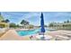 A stunning outdoor pool area with lounge chairs, umbrellas and a clubhouse, perfect for relaxation and community social events at 492 Sweetwater Way, Haines City, FL 33844
