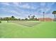 A well-maintained tennis court under a bright sky, promising an active lifestyle within the community and stunning scenery at 492 Sweetwater Way, Haines City, FL 33844