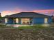 The home has a cozy covered patio and ample backyard space for entertaining at 541 Hatchwood Dr, Haines City, FL 33844