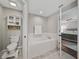 Bathroom featuring bathtub, and view into the main bedroom at 541 Hatchwood Dr, Haines City, FL 33844