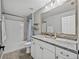 Bathroom featuring a tub/shower combo, vanity with marble countertops and large mirror at 541 Hatchwood Dr, Haines City, FL 33844