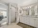 Bathroom with double vanity, large mirror, and a glass enclosed tile shower at 541 Hatchwood Dr, Haines City, FL 33844