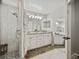 Bathroom with double vanity, large mirror, and a glass enclosed tile shower at 541 Hatchwood Dr, Haines City, FL 33844