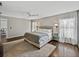 Spacious bedroom with a large rug, neutral walls, hardwood floors, and ceiling fan at 541 Hatchwood Dr, Haines City, FL 33844