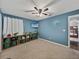 Bright bedroom featuring neutral carpet, blue walls, ceiling fan and built-in shelving at 541 Hatchwood Dr, Haines City, FL 33844