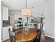 Bright open layout with dining area, wooden table, kitchen, and view into the living area at 541 Hatchwood Dr, Haines City, FL 33844