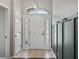 Bright foyer with decorative light fixtures, a white front door with glass panels, and a gray accent wall at 541 Hatchwood Dr, Haines City, FL 33844