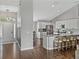 Open concept kitchen and entrance with stainless steel appliances, a center island, and wooden floors at 541 Hatchwood Dr, Haines City, FL 33844