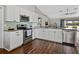 Bright kitchen with stainless steel appliances and a view into the living room at 541 Hatchwood Dr, Haines City, FL 33844
