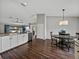 Spacious kitchen dining area with wood floors and views of the living room and back yard at 541 Hatchwood Dr, Haines City, FL 33844