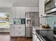 Modern kitchen with white cabinets, stainless steel appliances, and tiled backsplash at 541 Hatchwood Dr, Haines City, FL 33844