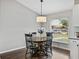 Cozy kitchen nook with a round wood table and modern light fixture at 541 Hatchwood Dr, Haines City, FL 33844