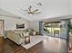 Comfortable living room with hardwood floors, large sectional sofa, and access to the backyard at 541 Hatchwood Dr, Haines City, FL 33844