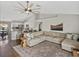 Inviting open-concept living room with hardwood floors, flows into the kitchen and dining area at 541 Hatchwood Dr, Haines City, FL 33844
