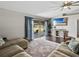 Living room with hardwood floors, comfortable sectional sofa, and sliding glass doors to the patio at 541 Hatchwood Dr, Haines City, FL 33844