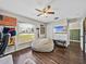 Spacious office with wood-look floors, a large window, sports memorabilia, and a ceiling fan at 541 Hatchwood Dr, Haines City, FL 33844