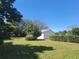 Spacious backyard features a lush lawn, mature trees, and ample privacy at 5702 Breskin Dr, Orlando, FL 32839