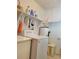 Functional laundry room with white washer, dryer, and shelving for storage at 5702 Breskin Dr, Orlando, FL 32839