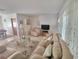 Bright living room with comfortable sofas, a glass table, and decorative curtains, creating a welcoming atmosphere at 5702 Breskin Dr, Orlando, FL 32839
