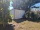 Exterior of a backyard storage shed surrounded by greenery and a tidy lawn at 5702 Breskin Dr, Orlando, FL 32839