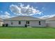 Expansive backyard with lush green grass, a well-maintained patio, and a clean exterior at 620 Jaxson Blvd, Winter Haven, FL 33880