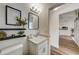 Well-lit bathroom features a decorative shelf, modern lighting, and white vanity at 620 Jaxson Blvd, Winter Haven, FL 33880