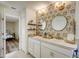 Stylish bathroom featuring double sinks, patterned accent wall, and modern fixtures at 620 Jaxson Blvd, Winter Haven, FL 33880