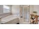 Elegant bathroom featuring a soaking tub, separate shower, and stylish fixtures at 620 Jaxson Blvd, Winter Haven, FL 33880