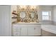 Bright bathroom with double sinks, decorative wall, and a luxurious soaking tub at 620 Jaxson Blvd, Winter Haven, FL 33880