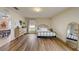 Cozy bedroom with wood-look floors, decorative wall, and ample natural light, with dining room view at 620 Jaxson Blvd, Winter Haven, FL 33880