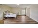 Spacious bedroom with wood-look floors, decorative wall, and large windows at 620 Jaxson Blvd, Winter Haven, FL 33880