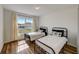 This sun-filled bedroom features matching beds, wood-look floors, and a large window at 620 Jaxson Blvd, Winter Haven, FL 33880