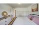 This bedroom offers ample closet space, wood-look floors, a comfy bed, and natural light at 620 Jaxson Blvd, Winter Haven, FL 33880