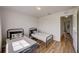 Well-lit bedroom features matching beds, wood-look floors, and an open doorway at 620 Jaxson Blvd, Winter Haven, FL 33880