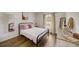 Bright bedroom showcasing a bed with wood-look floors and natural light from the window at 620 Jaxson Blvd, Winter Haven, FL 33880