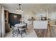 Charming dining space with modern lighting and adjacent to a kitchen with white cabinetry at 620 Jaxson Blvd, Winter Haven, FL 33880