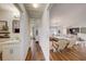 Hallway view into a living area with hardwood floors and neutral colors with adjacent bathroom at 620 Jaxson Blvd, Winter Haven, FL 33880