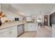 Bright, open kitchen with white cabinets, stainless steel appliances, and a view to the breakfast nook at 620 Jaxson Blvd, Winter Haven, FL 33880
