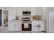 Modern kitchen with stainless steel appliances, bright white cabinetry, and a functional layout at 620 Jaxson Blvd, Winter Haven, FL 33880