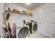 Bright laundry room featuring modern washer and dryer with ample shelving for storage at 620 Jaxson Blvd, Winter Haven, FL 33880