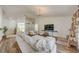Bright living room boasts wood floors, a vaulted ceiling, and modern furnishings at 620 Jaxson Blvd, Winter Haven, FL 33880