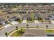 Aerial view of a home, its driveway, surrounding houses, and the neighborhood at 622 Taft Dr, Davenport, FL 33837